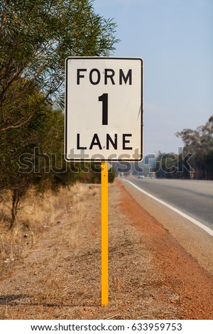 An Australian road sign indicating that the overtaking lane is ending and for all traffic to merge to a single lane. This specific sign was on the Great Eastern Highway, Rural Western Australia.