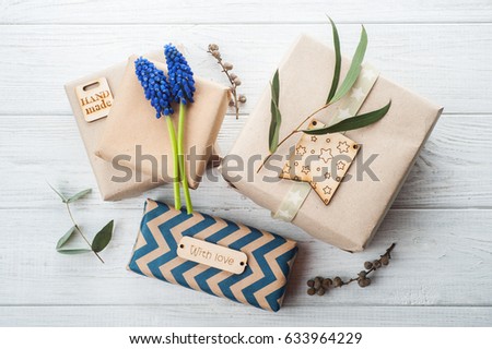 Gift Boxes with Tag Love. Wooden background, floral decor, blue flowers.