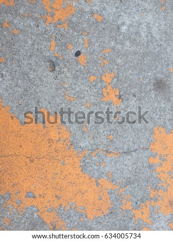 Texture of the cement and yellow color on the floor.