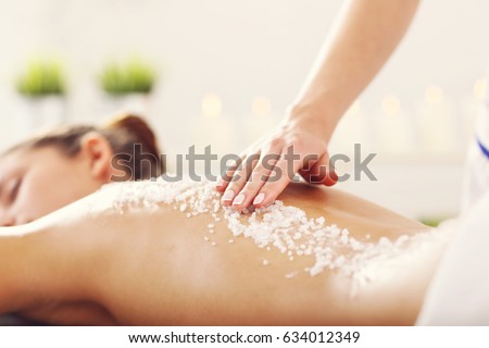 Beautiful woman having exfoliation treatment in spa Royalty-Free Stock Photo #634012349