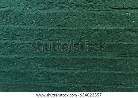 Close-up of the bottle green painted brick wall background texture