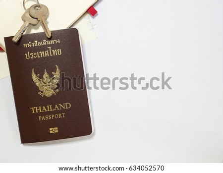 Thailand passport, keys and note with white space.