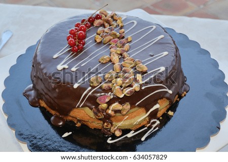 Sette veli cake garnished with melted chocolate and dried fruit