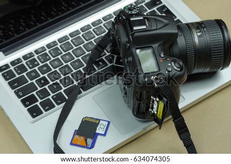 Digital Camera with laptop in the background.