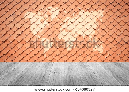 Tile roof of old Thai temple texture background surface natural color , process in vintage style with white wood terrace with world map