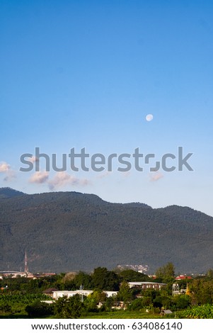 Scenic View of Daylight moon and house with huge garden surrounded