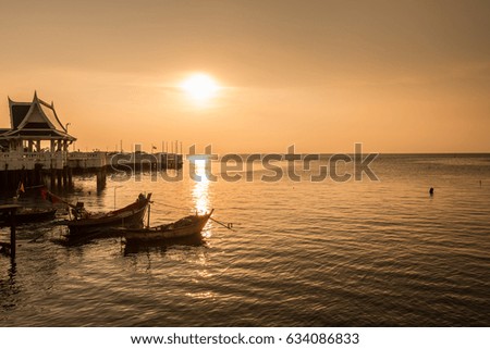 Small fishing Boat is floating under the sunset at Bangsaen Chonburi Thailand