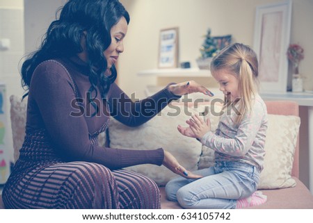 African American woman playing with girl. Woman plating wit her adopted daughter. Royalty-Free Stock Photo #634105742