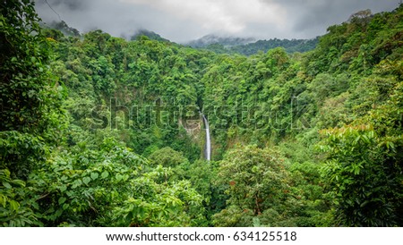 Wide angle view of La Fortuna de San Carlos waterfall in Arenal volcano national park, Costa Rica Royalty-Free Stock Photo #634125518