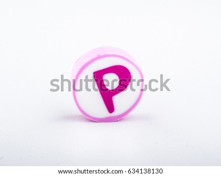 P Isolated alphabet printed on the round shape eraser on white background for learning purposes. Copy space for text and logo. 