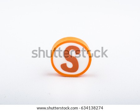 S isolated alphabet printed on the round shape eraser on white background for learning purposes. Copy space for text and logo. 