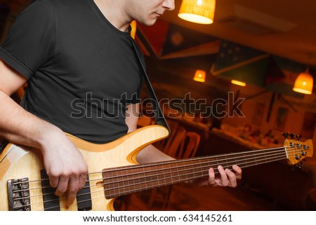 Man playing the guitar close-up in restaurant