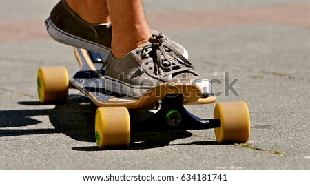Long boarder skating on concrete