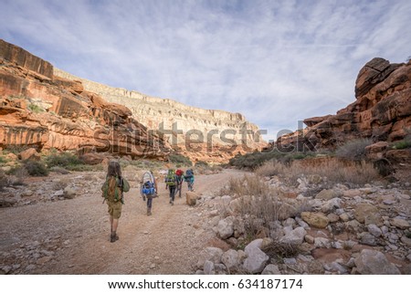 Group of Hikers backpacking through the Grand Canyon to Havasu Falls, Arizona Royalty-Free Stock Photo #634187174
