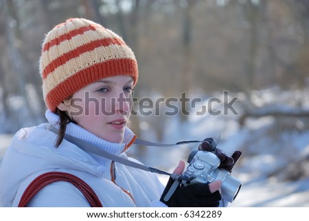 Young photographer on winter background