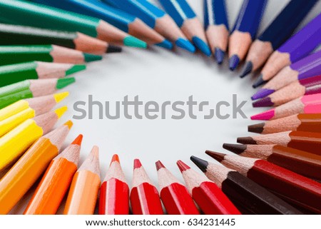 Colorful bunch of multicolored vibrant colored pencils on white background macro