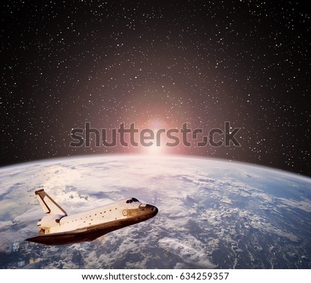 Shuttle spaceship against earth on the background. Outer space. "The elements of this image furnished by NASA"
