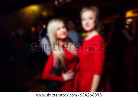 blurred women men in nightclub 
