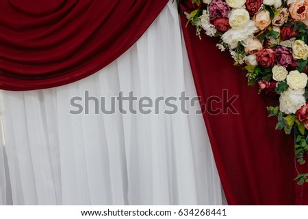 colorful flowers on theather red curtains