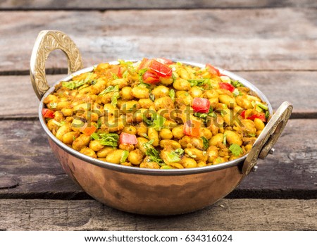 Indian Cuisine Rajma Masala or Rajmah is a South Asian Vegetarian Dish Consisting of White Kidney Beans in a thick gravy with many Indian whole spices and usually served with Chapati and food