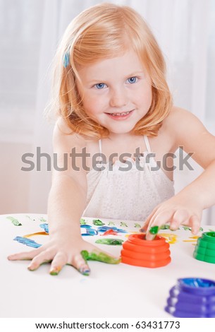  girl with colorful paints ready for hand prints