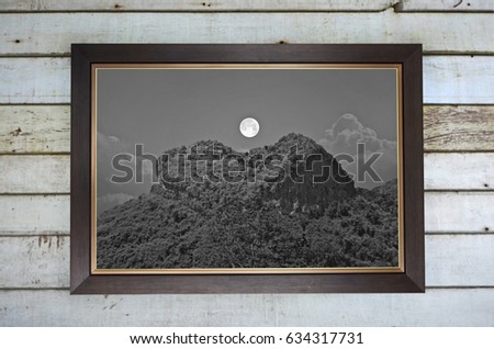 Old image of full moon and mountain heart on the wall