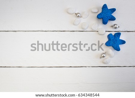 Background with white, pearl necklace pendants, beach pebbles and blue starfish on white wooden planks - concept of relaxation and luxury