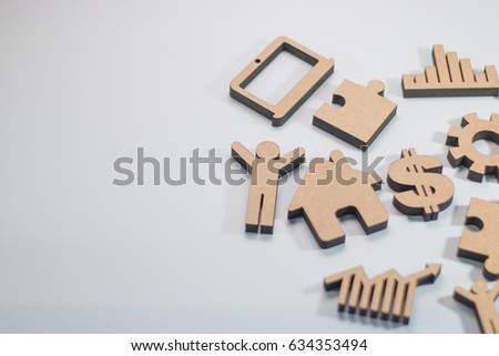Wood figure with business icons on white background, finance concept