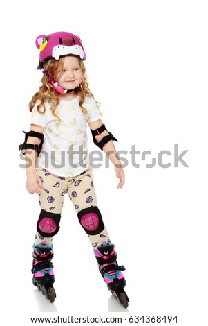 Beautiful, chubby little girl with long, blond,curly hair.Girl riding roller skates in protective gear.Isolated on white background.