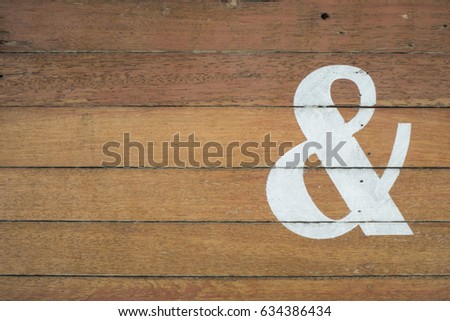 ampersand & sign painted on wooden background