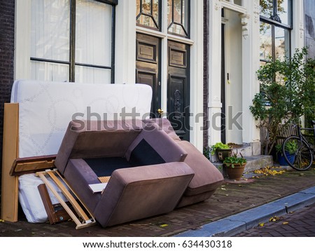 Used furnitures in front of a house Royalty-Free Stock Photo #634430318