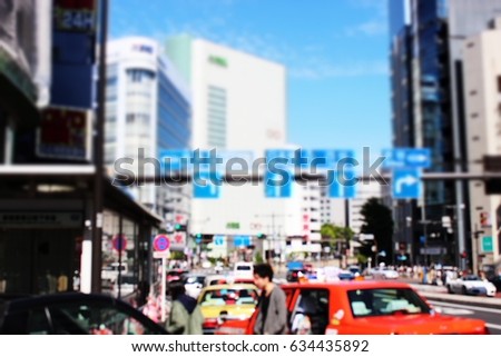 Blurred cars and street sign and building