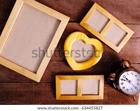 blank photo frames on the table wooden background