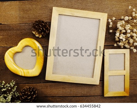 blank photo frames on the table wooden background