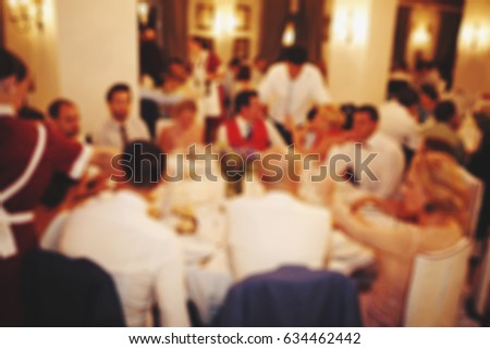 Blurred people in the banquet room with gala dinner