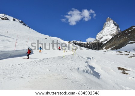Skiers in Matterhorn in background, Zermatt in Swiss Alps