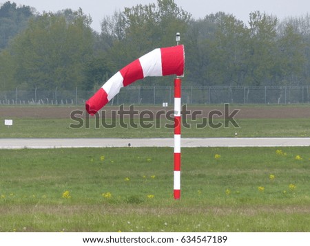 Red, white windsock at an international airport in Germany