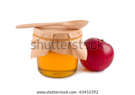 Honey in jar wooden spoon red apple isolated.