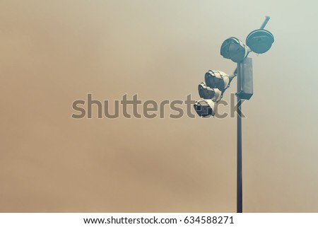 Flood lights against grey sky background. Copy space for text
