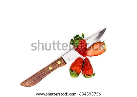 Knife stab middle strawberry isolated on white