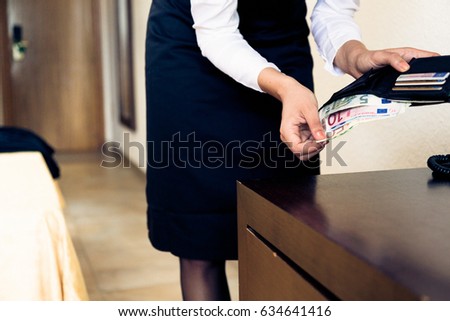 Room Maid Looking Through Hotel Guest's Wallet