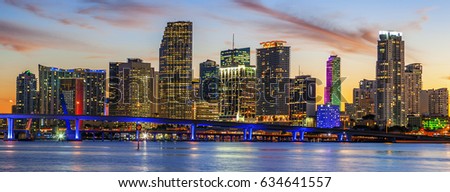 CIty of Miami Florida, summer sunset panorama with colorful illuminated business and residential buildings and bridge on Biscayne Bay 