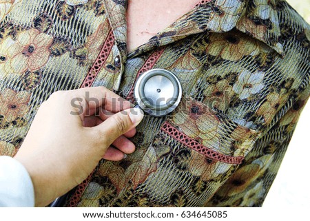 Doctor, physician with a stethoscope in the hands at workplace - health care, people and medical concept