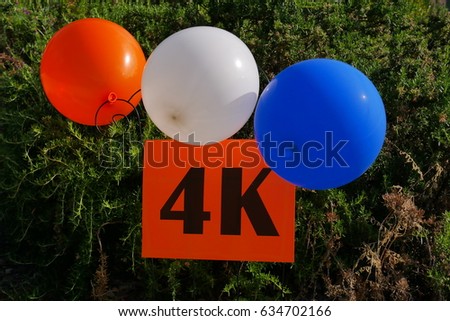 Set ballon and 4k sign hanging on the fence.