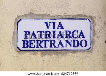 Ceramic place signboard with blue writing TRANSLATION: PATRIARCH BERTRAND STREET