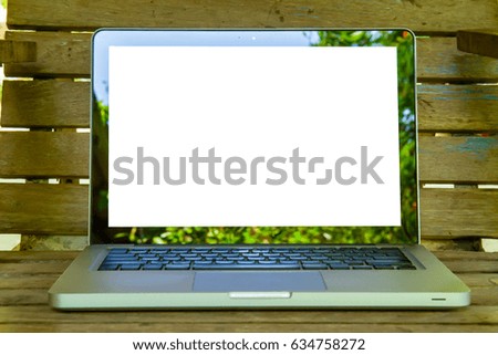 Laptop with black screen background on wooden table texture