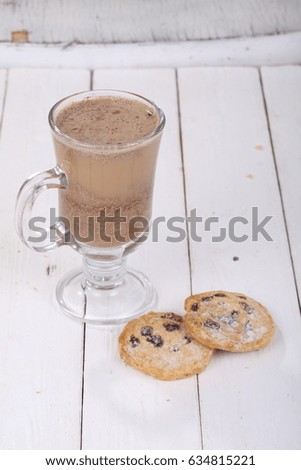 Cocoa with cinnamon cookies on white wooden background
