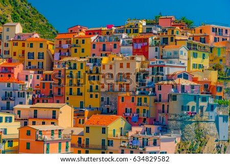 Scenic view of colorful village Manarola and ocean coast in Cinque Terre, Italy Royalty-Free Stock Photo #634829582
