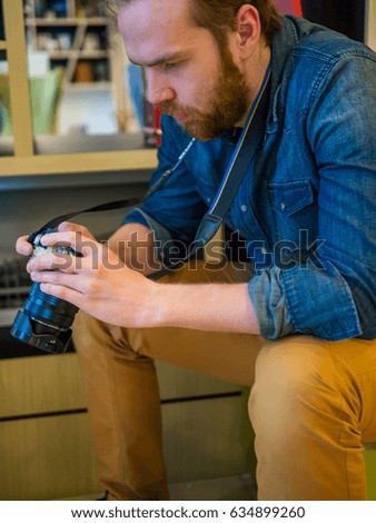 Photographer sits with a camera in his hand