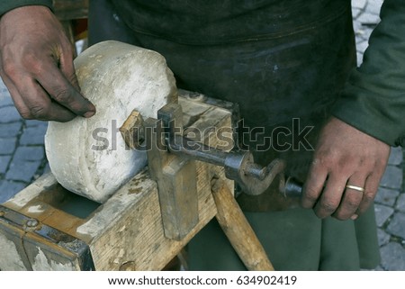 Blacksmith grinding on hand brushes